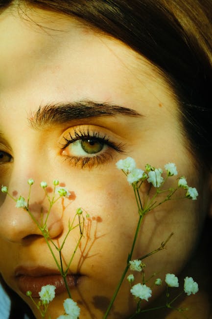 young woman performing gentle eye massage with peaceful expression in natural lighting